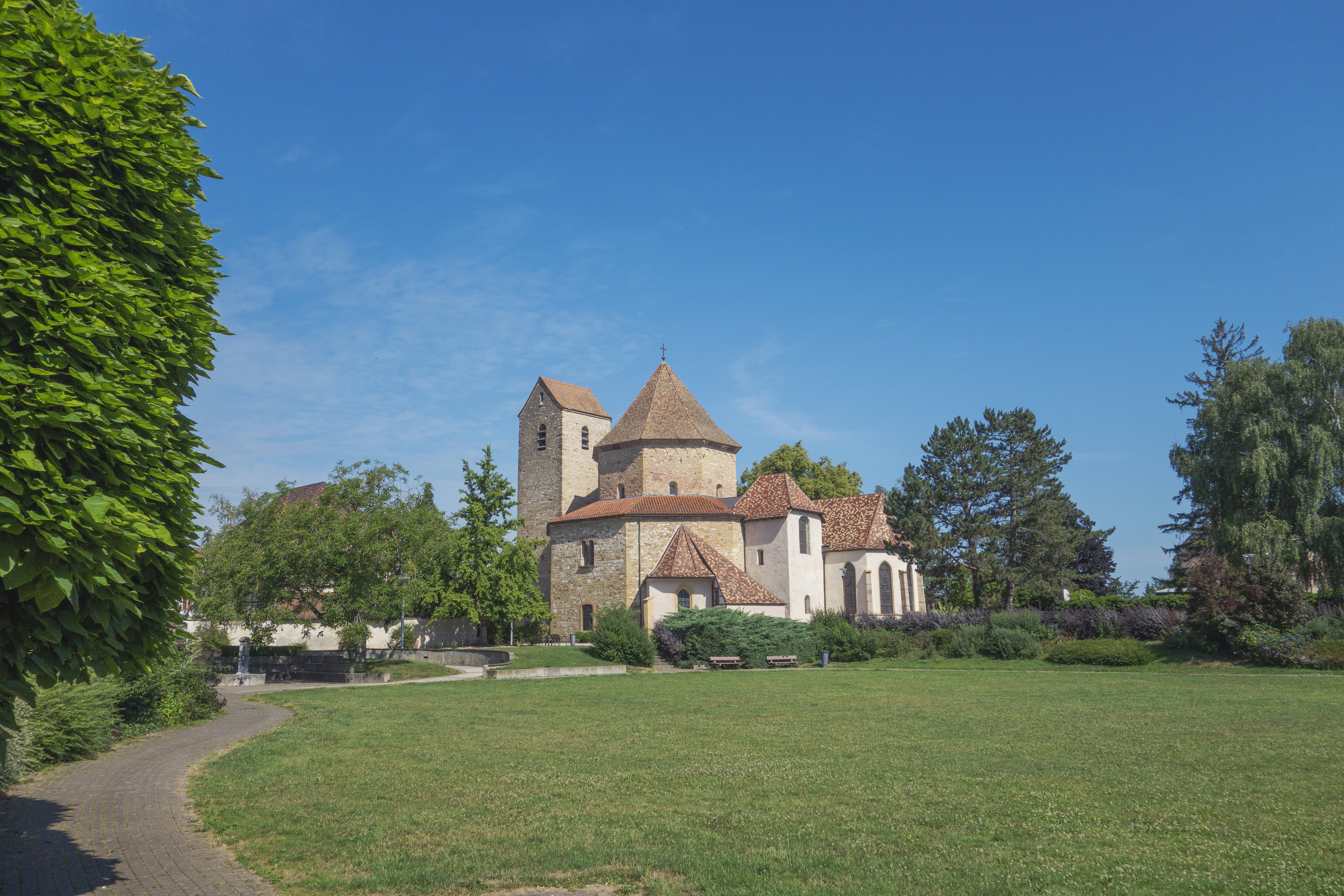 a large building sitting on top of a lush green field, 