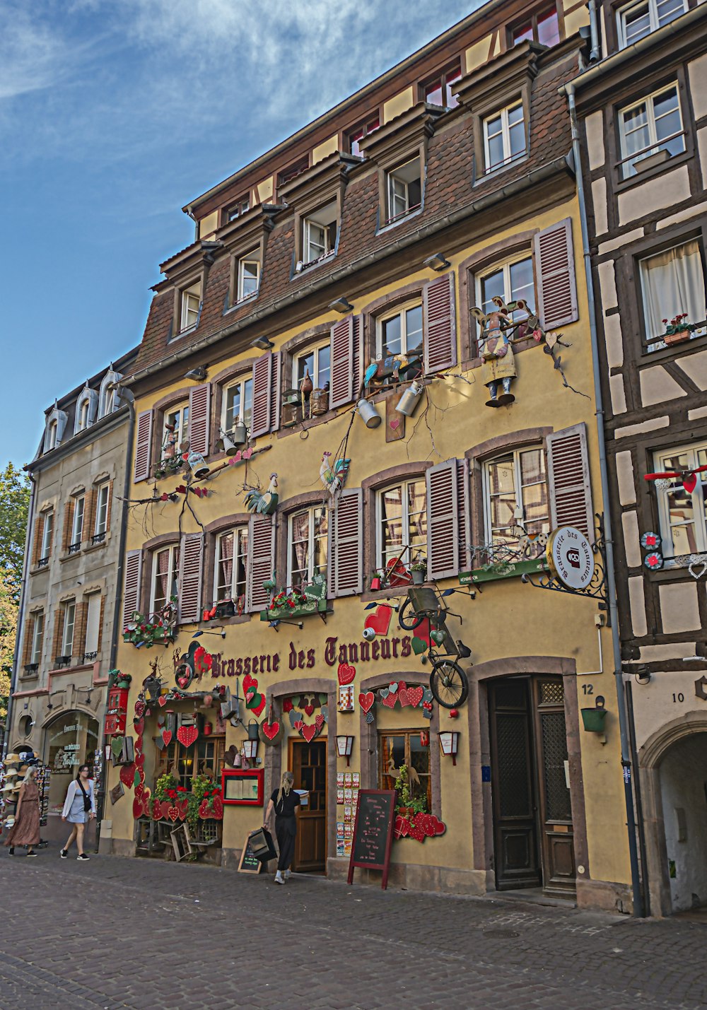 a tall building with lots of windows next to a street