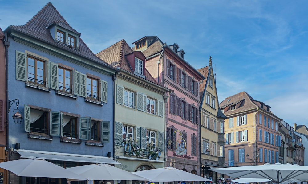 a row of buildings with umbrellas in front of them