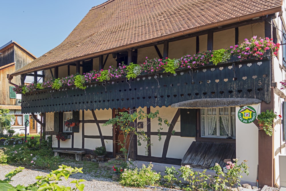 a house with flowers on the balconies