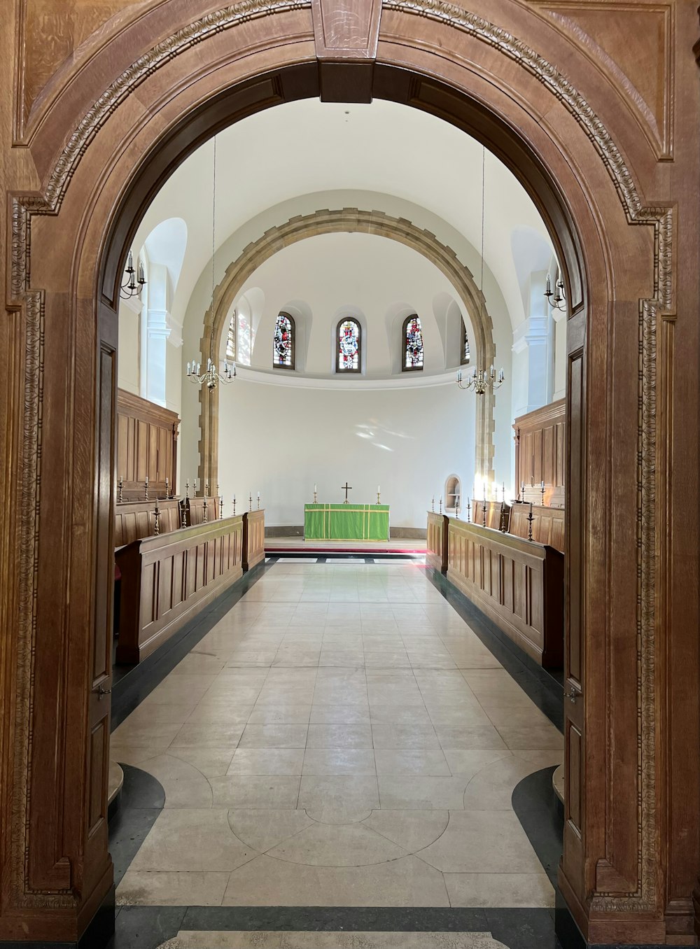 an arched doorway leading to a church with pews