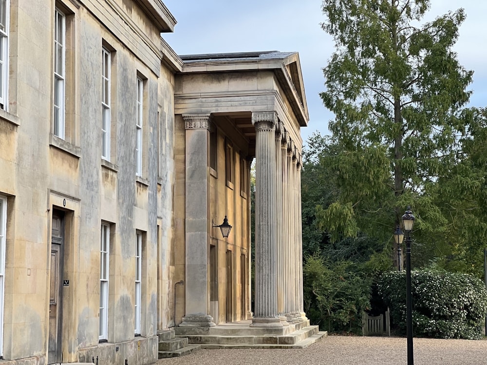 an old building with columns and a lamp post