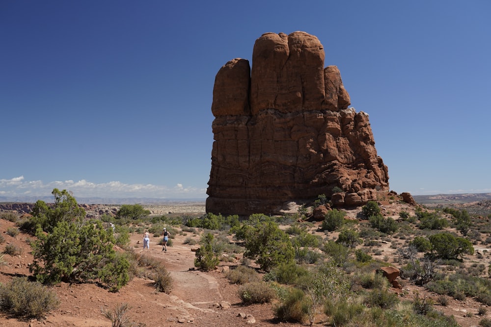 a large rock formation in the middle of a desert