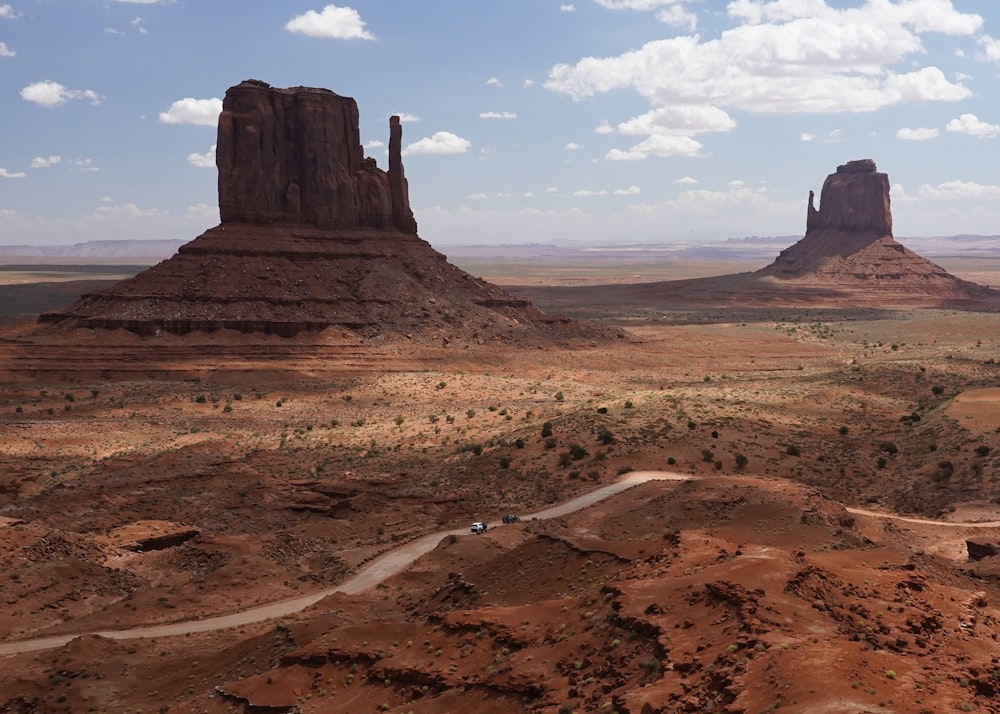 a scenic view of the desert with a road going through it