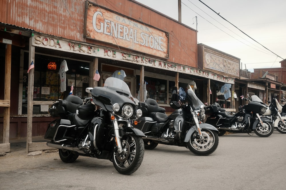 a row of motorcycles parked in front of a store
