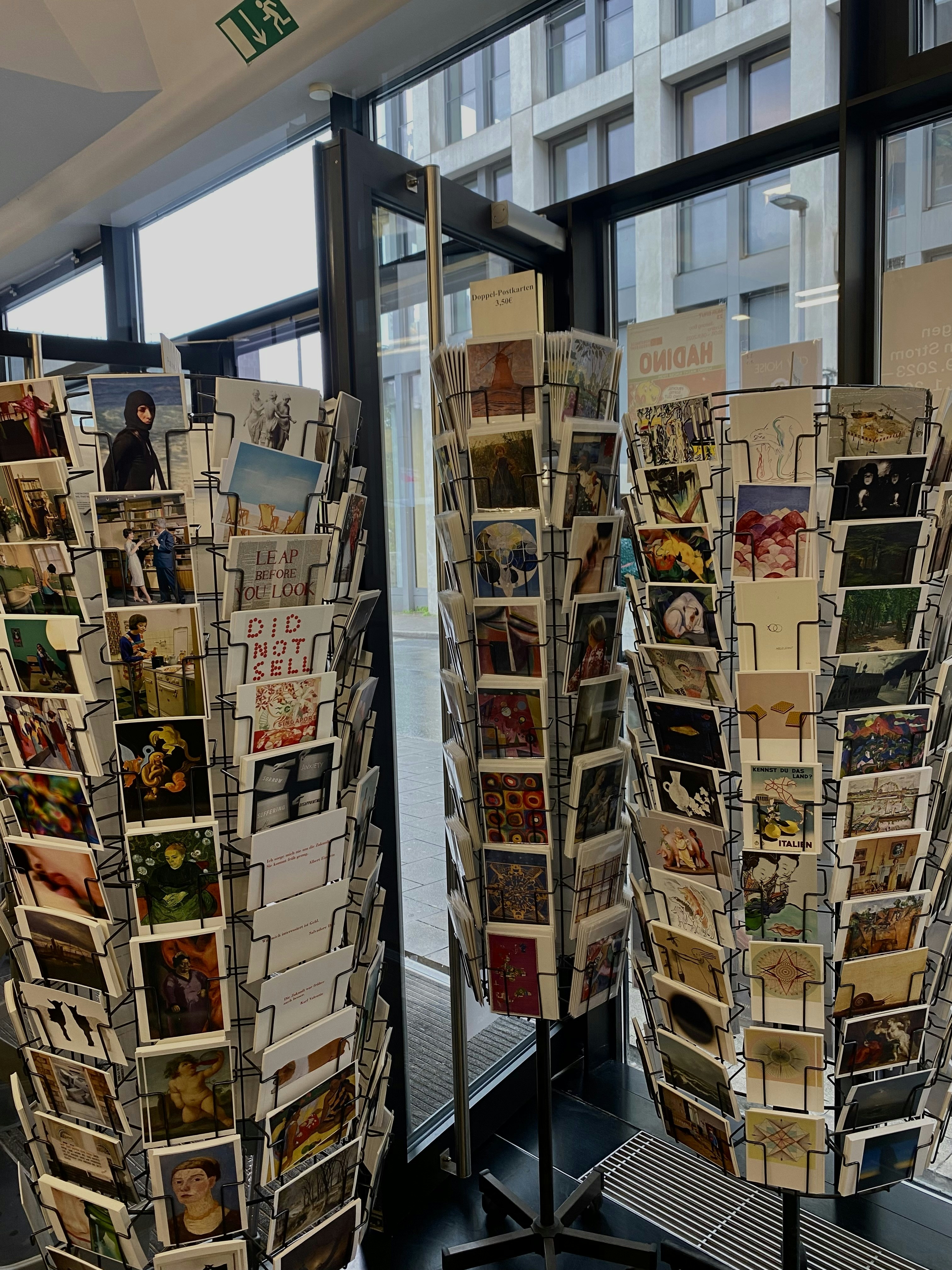 a couple of racks of brochures in front of a window