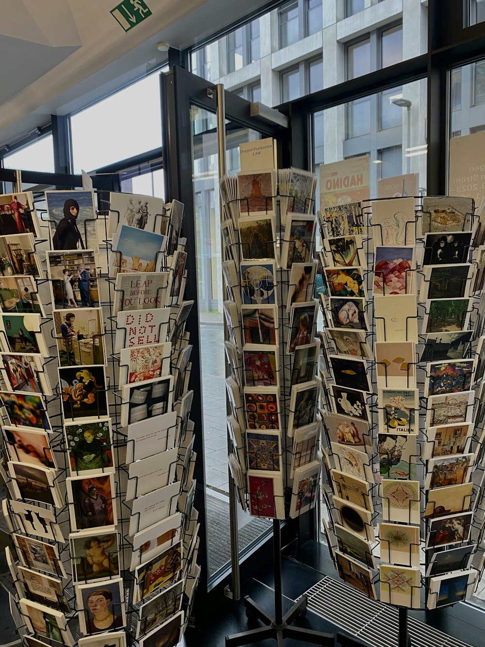 a couple of racks of brochures in front of a window