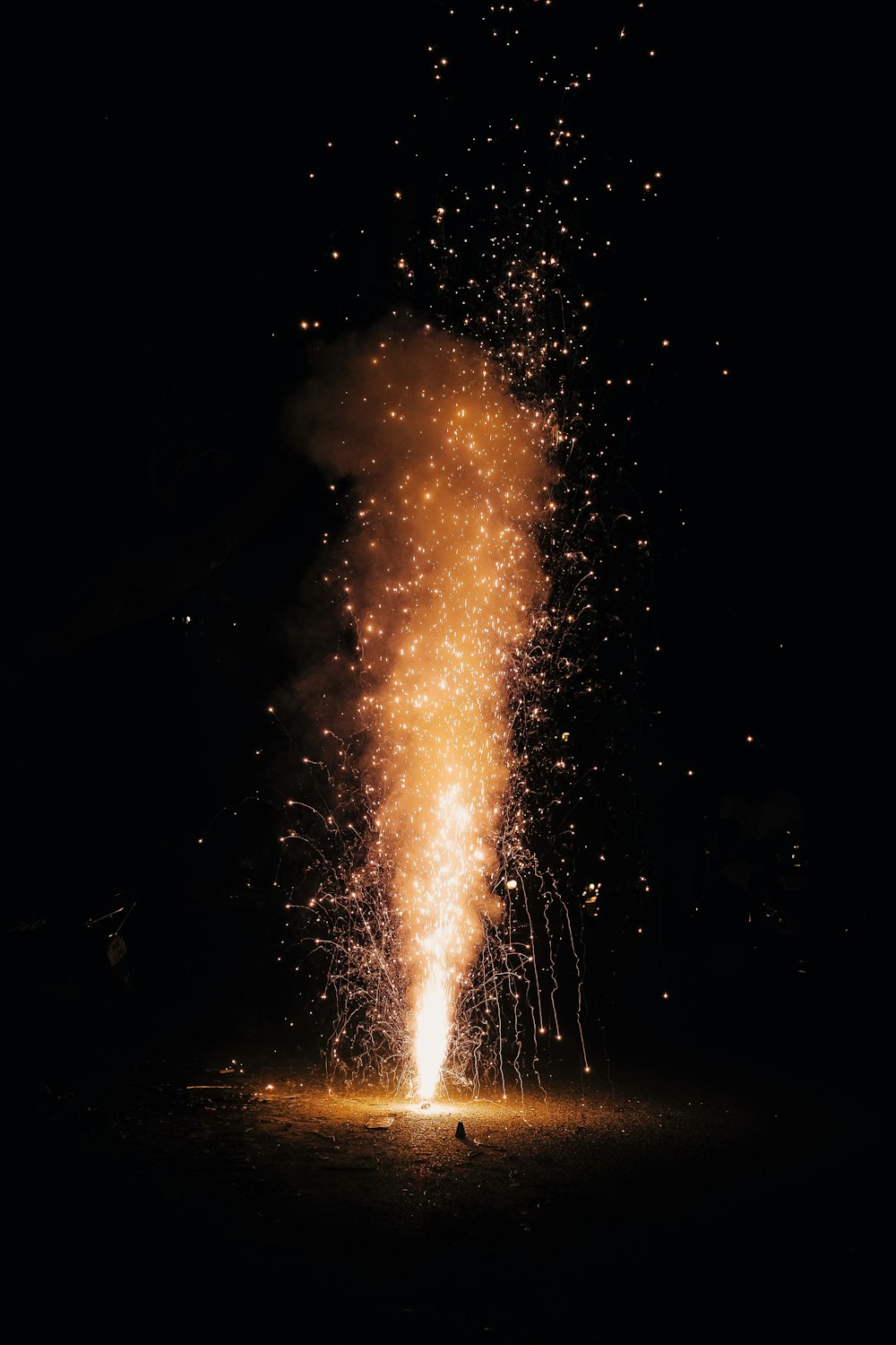 a firework is lit up in the night sky