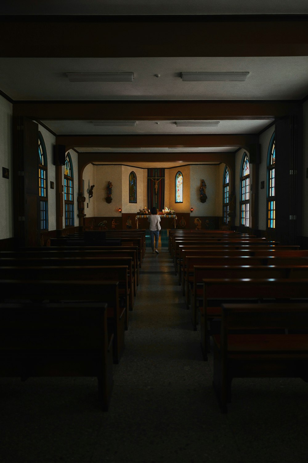 a church with pews and stained glass windows