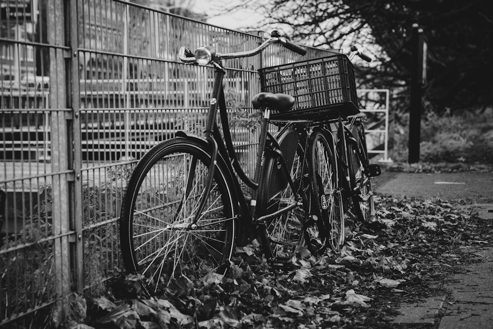 a bicycle is parked next to a fence