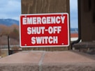 a red sign that says emergency shut - off switch