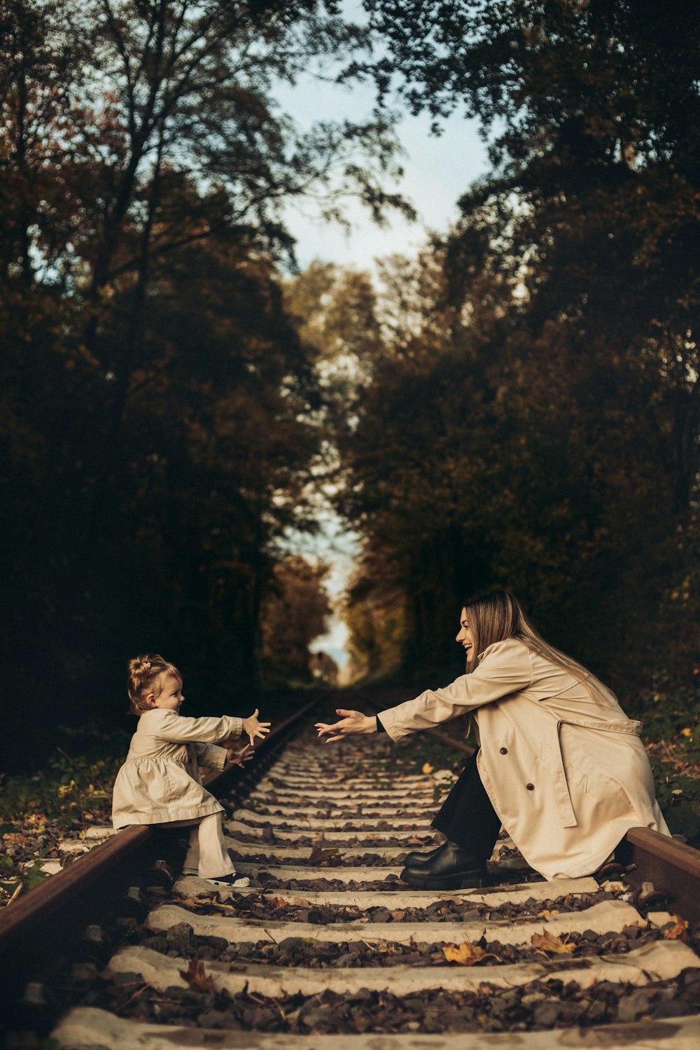 a woman and a child are sitting on a set of stairs