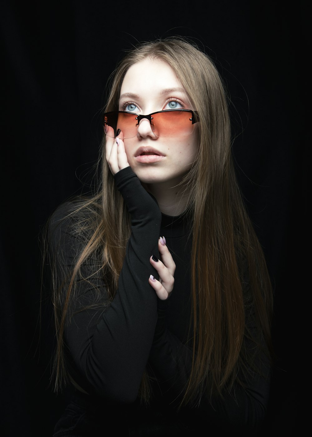 a woman with long hair and red glasses