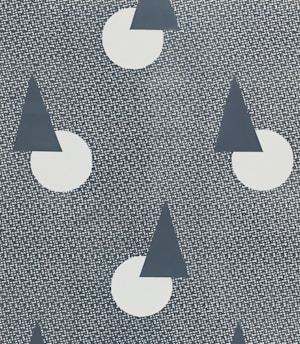 A repeating pattern features dark blue triangles partially overlapping white circles on a textured background. The texture consists of numerous small, white dots arranged in a grid-like fashion.
