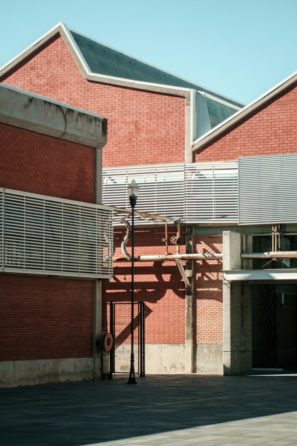 a red brick building with a metal balcony