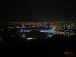 Nighttime view of the illuminated venue with Riyadh’s skyline in the background.