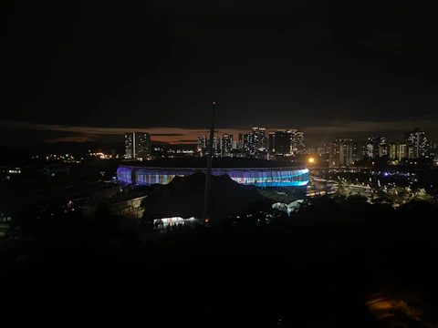 Nighttime stadium blurred background with subtle neon green accents