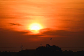 Bright orange sun rising over a starry sky symbolizing fresh astrological guidance.