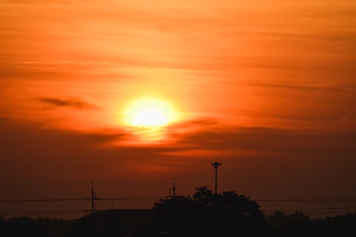 Bright orange sun rising over a starry sky symbolizing fresh astrological guidance.