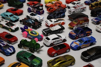 a table topped with lots of toy cars
