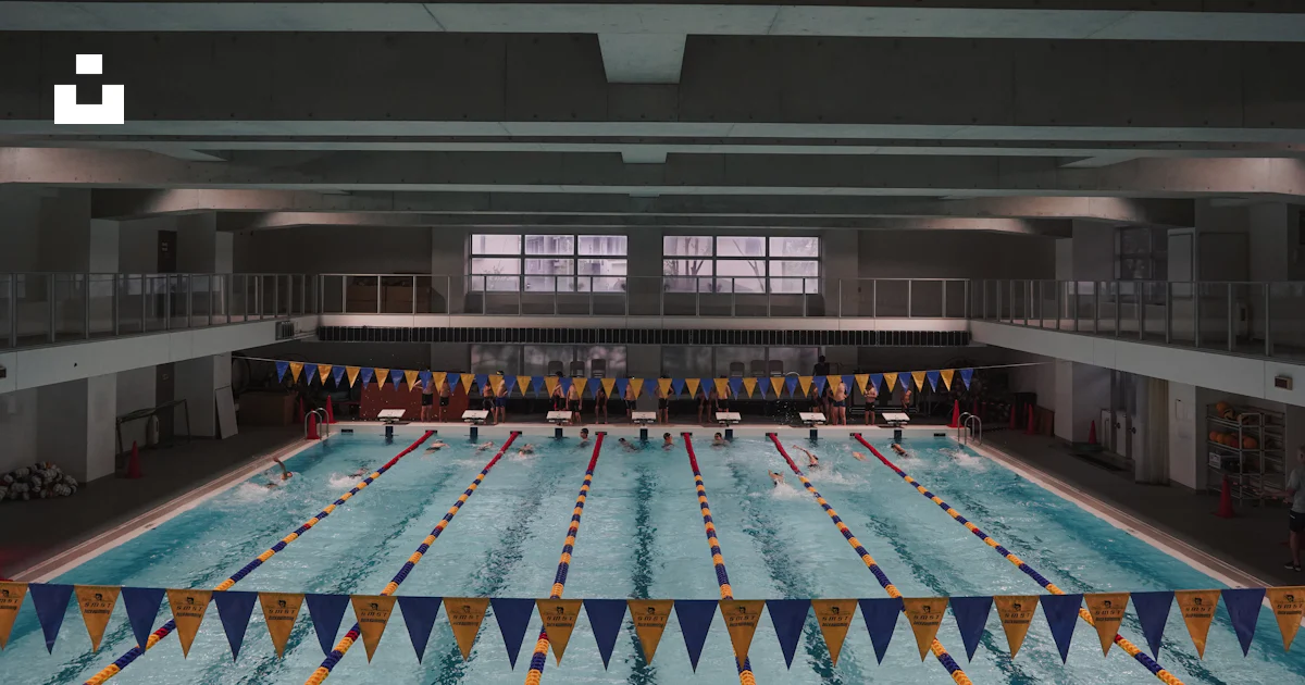 Pool Row A large swimming pool with a long row of flags photo – Free Building ...