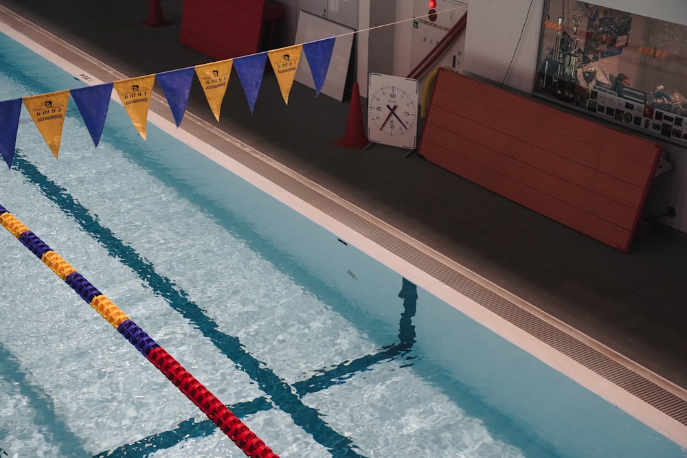 a swimming pool with a number of flags hanging from the side of it