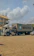 Photo of a happy customer standing next to a cargaviva container truck at a construction site.
