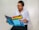 A happy person reading a magazine about neurodivergence.