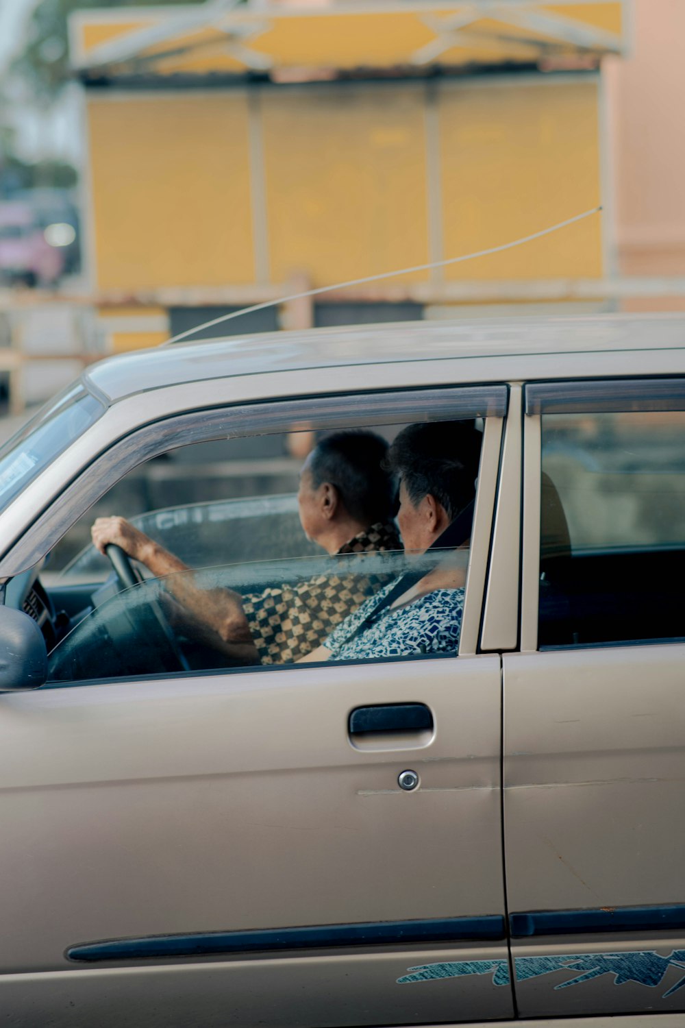 a couple of people sitting in a car