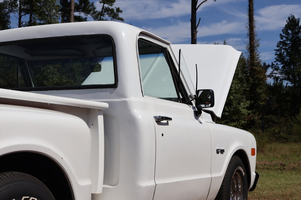 a white truck parked on the side of a road