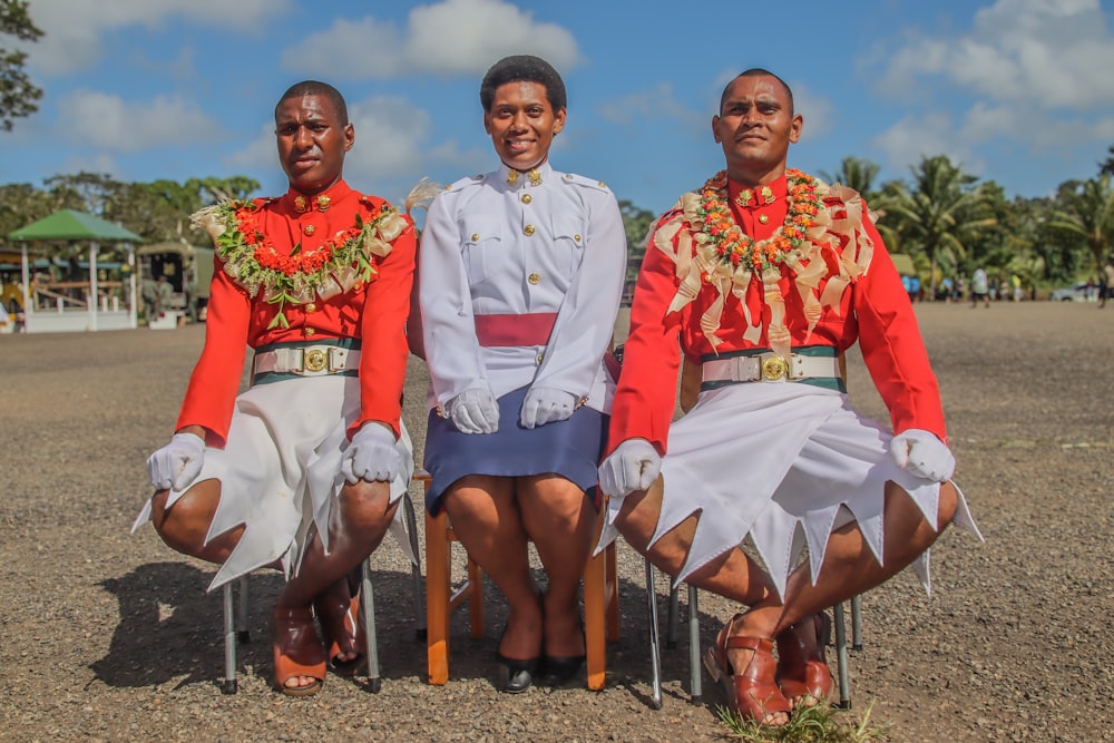 a group of three men sitting next to each other