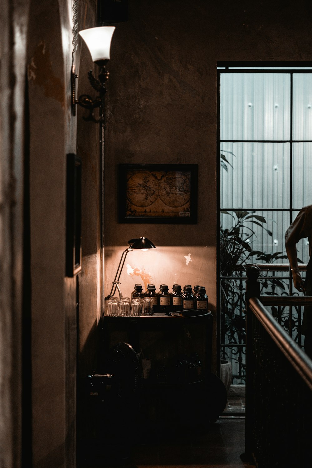 a man standing in a doorway next to a window