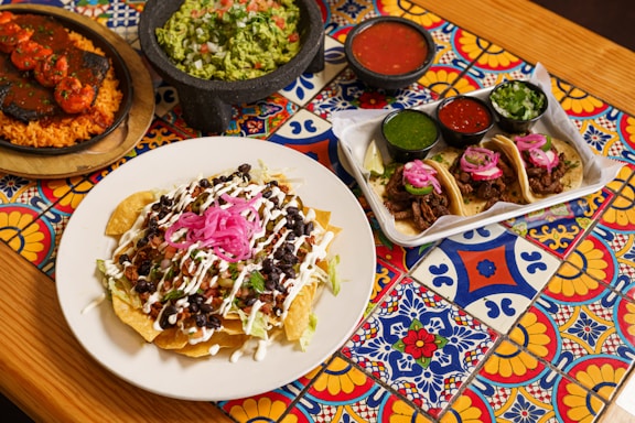 a table topped with plates of food and condiments