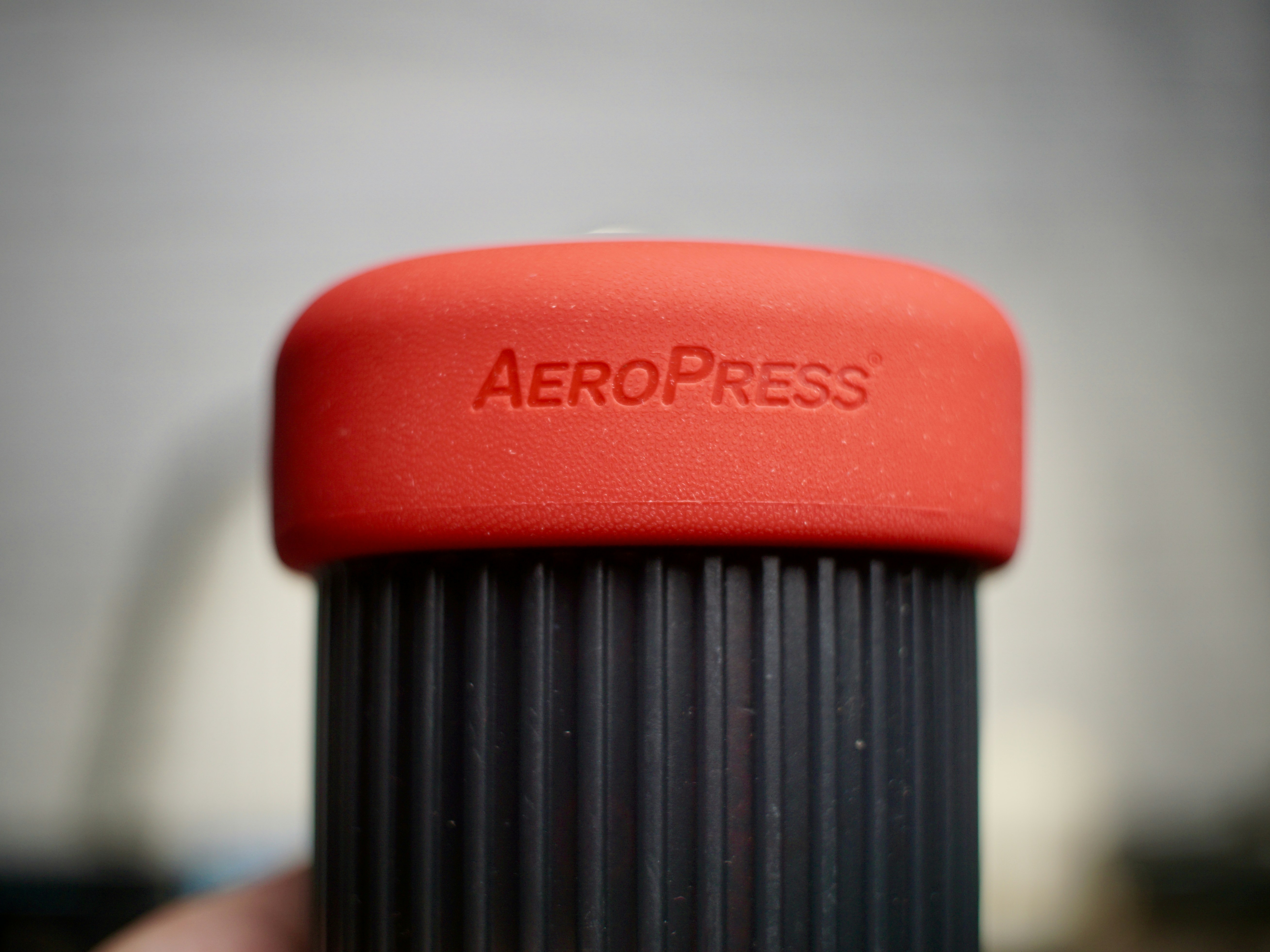 a close up of a red aeropress cup