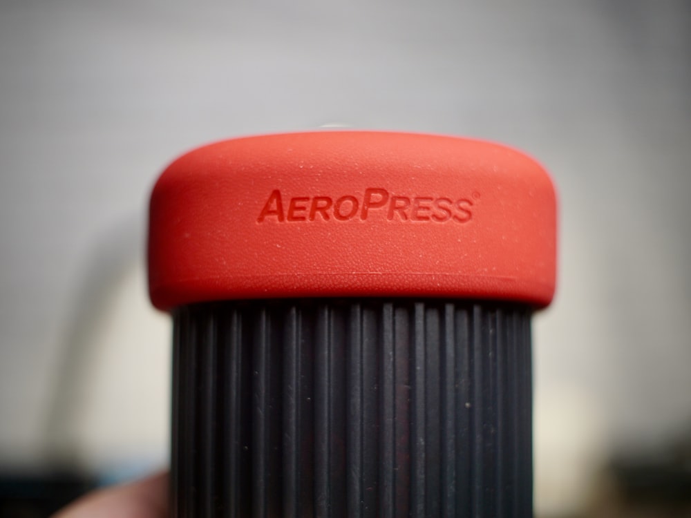 a close up of a red aeropress cup