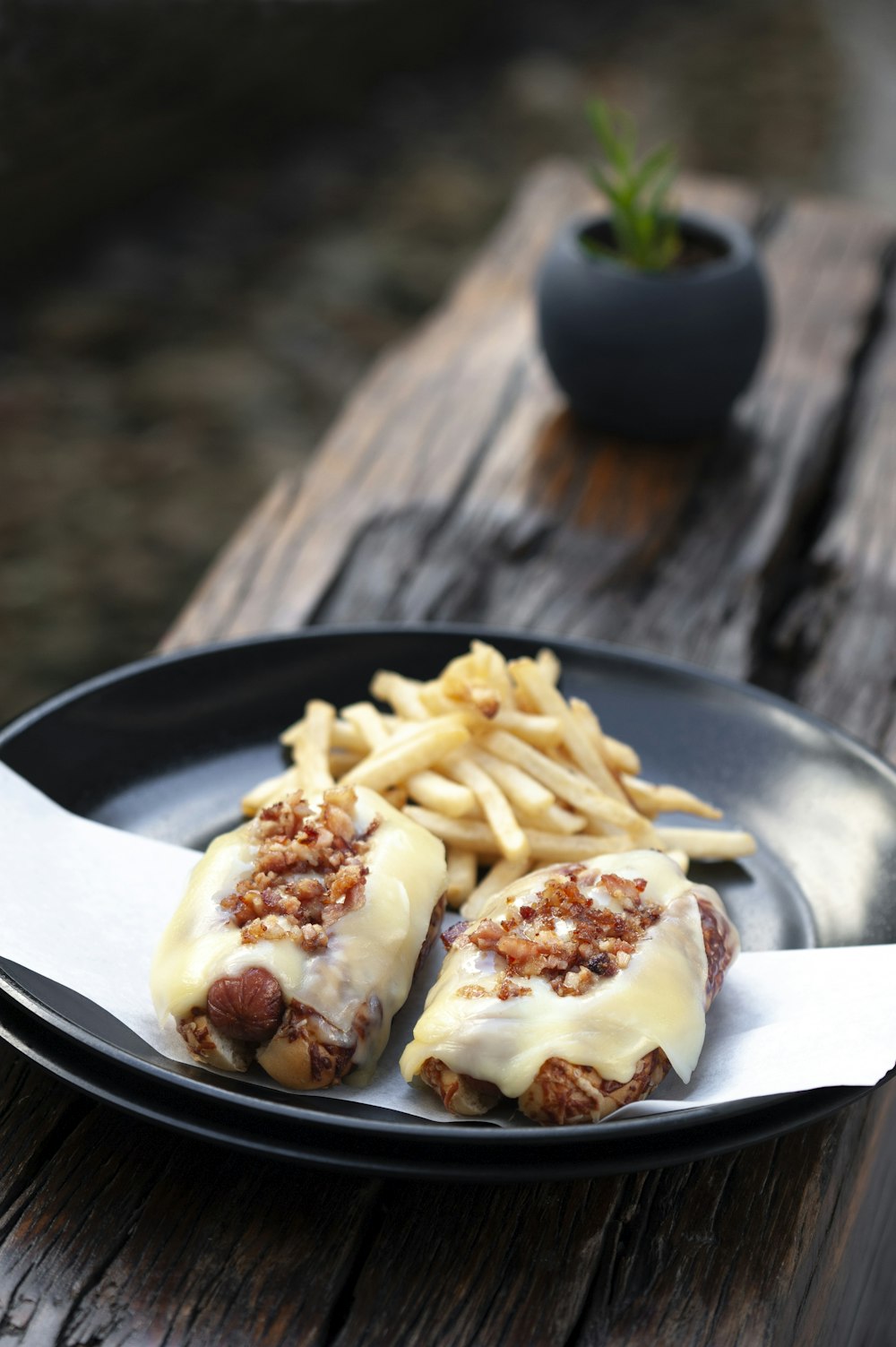 a plate of food with french fries on a wooden table