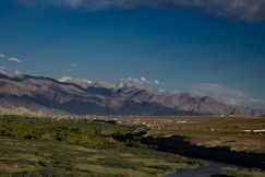 a river running through a lush green valley