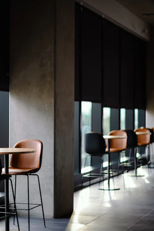 A chic corporate event space featuring minimalist pastel decor and subtle golden highlights.
