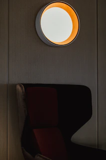 A sleek modern LED panel light glowing warmly in a minimalist living room setting