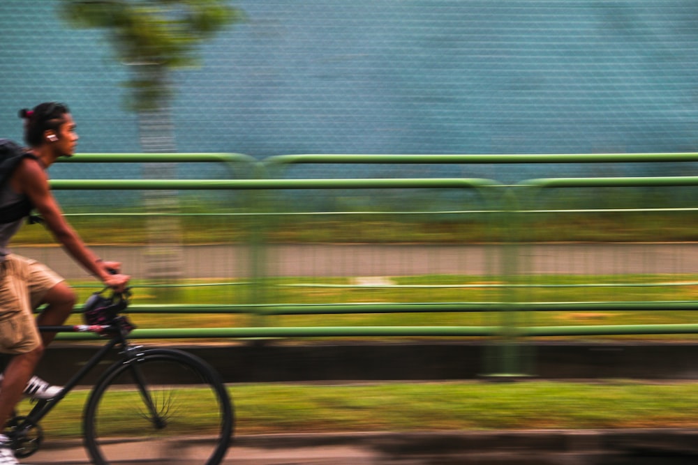 a man riding a bike down a street