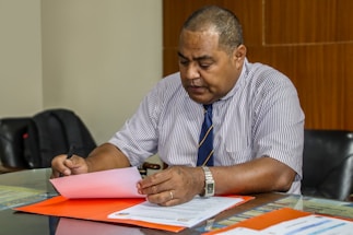 a man sitting at a table with papers in front of him
