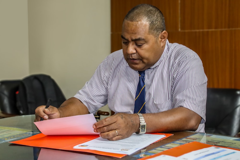 a man sitting at a table with papers in front of him