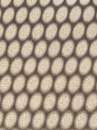 a close up view of a white surface with small circles