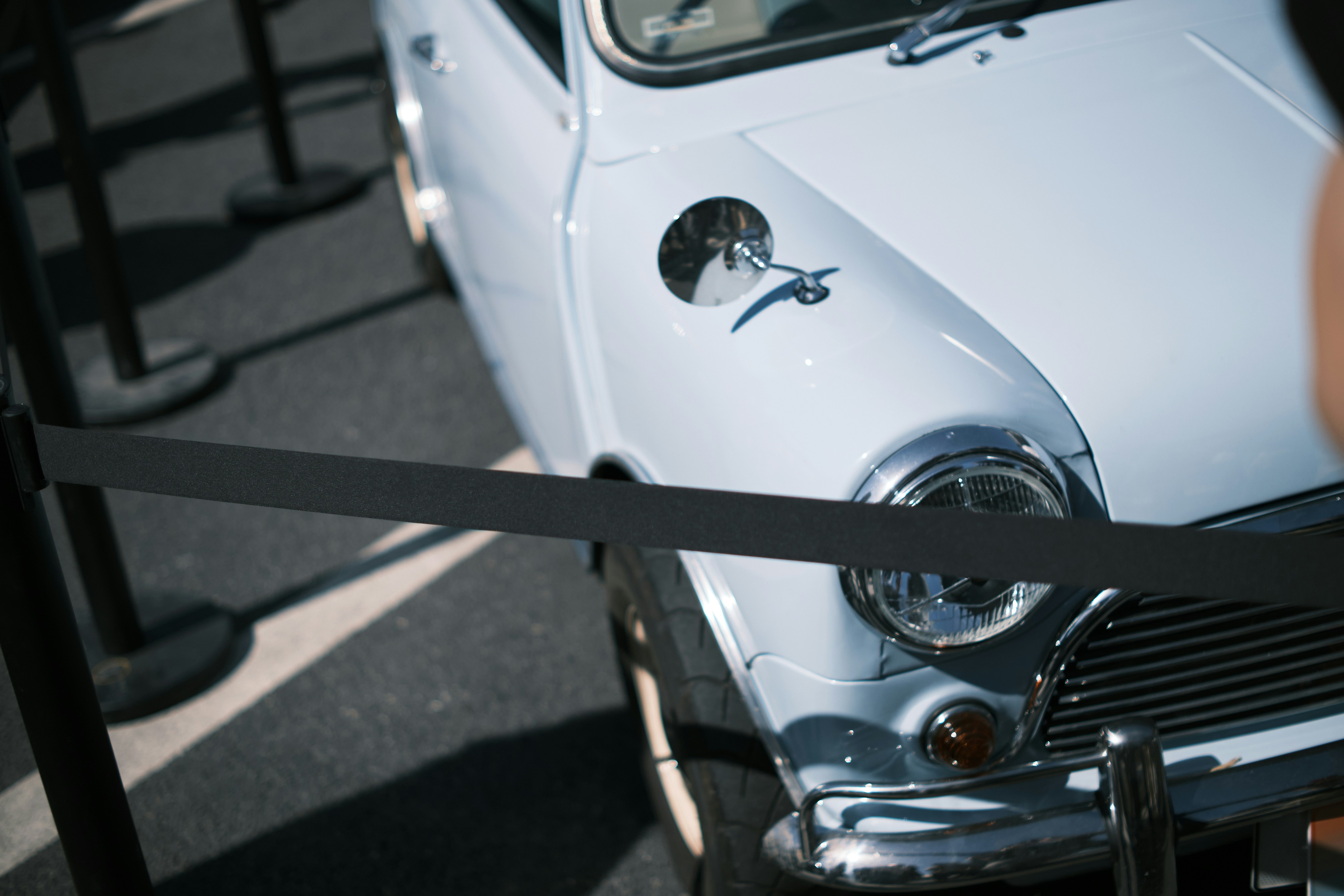 an old white car parked in a parking lot