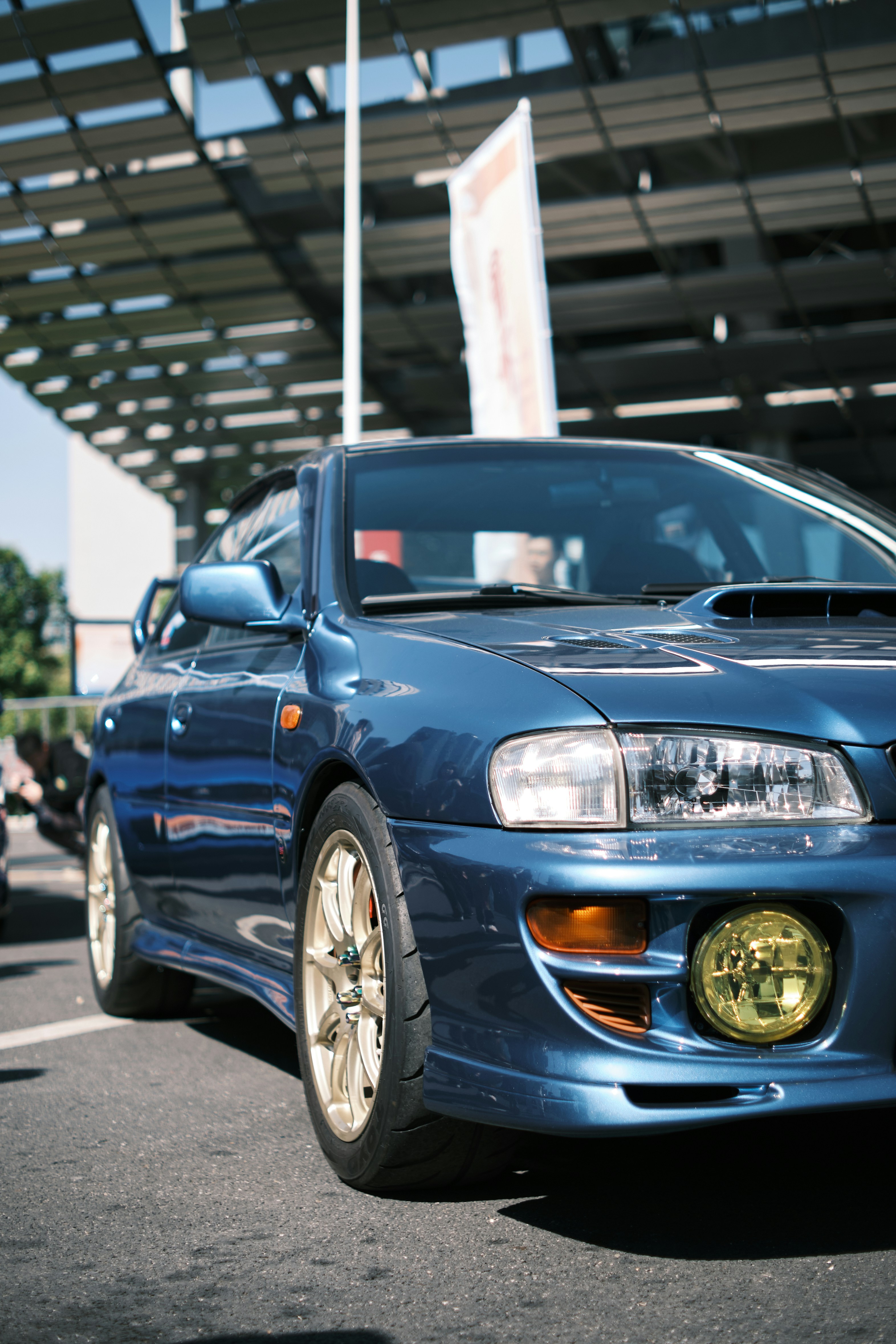 a blue car parked in front of a building