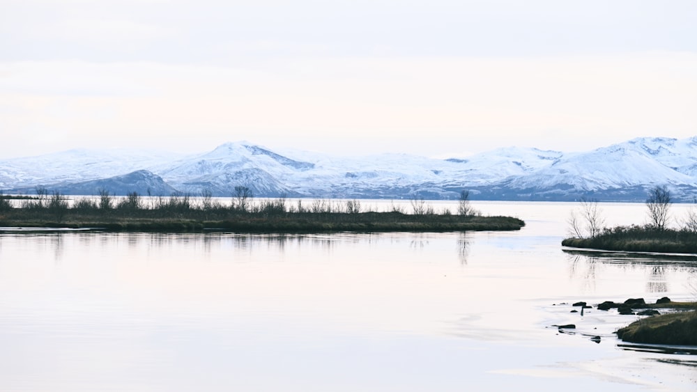 a large body of water with mountains in the background