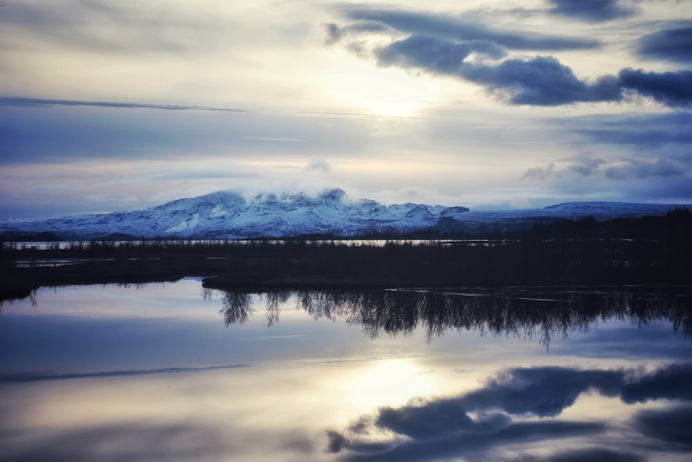 a body of water with a mountain in the background