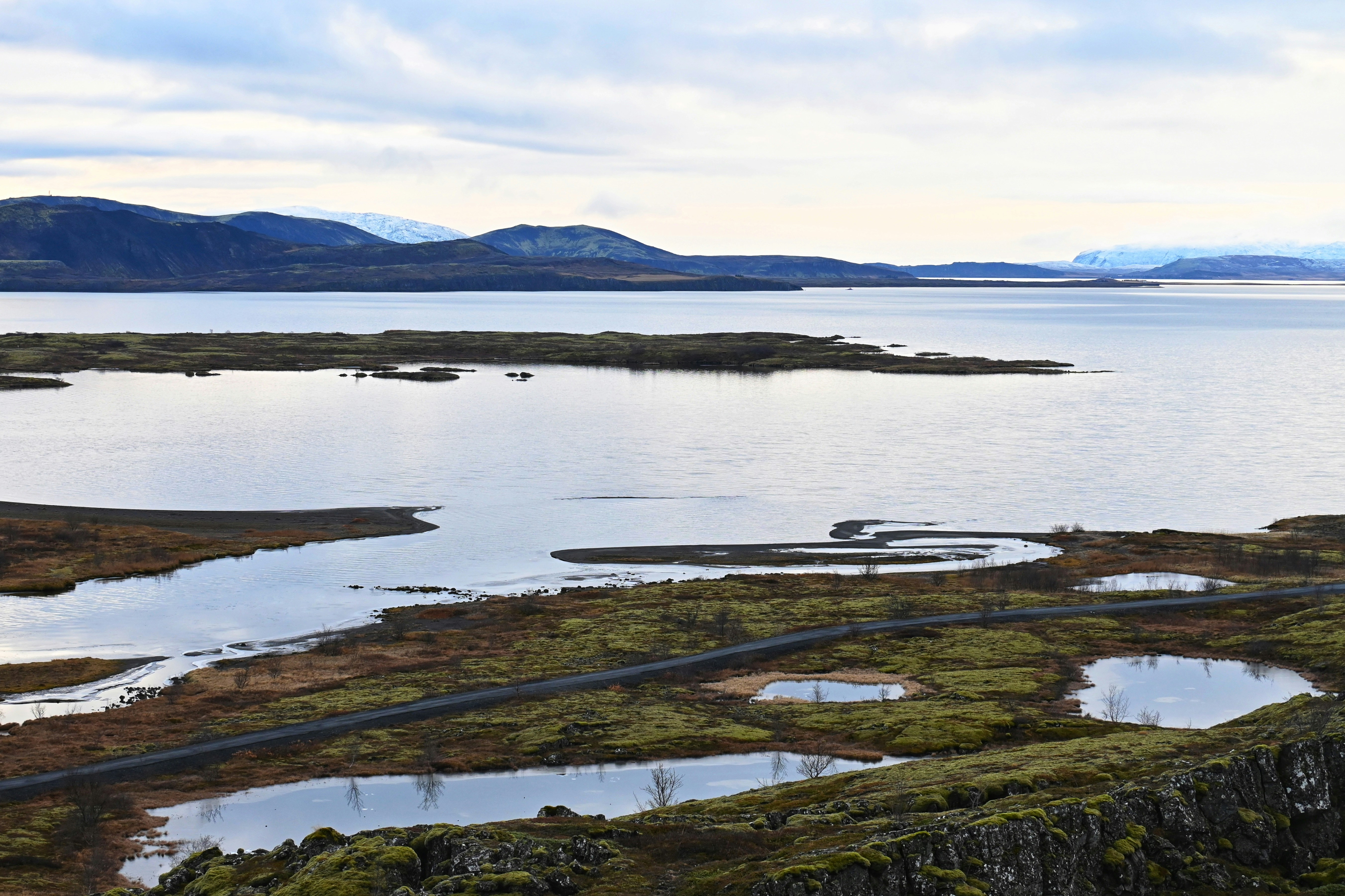 a large body of water surrounded by mountains, 