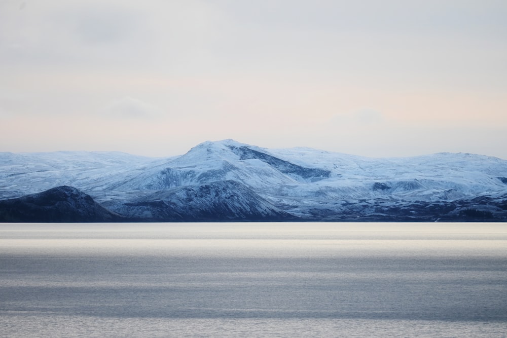 a large body of water with mountains in the background