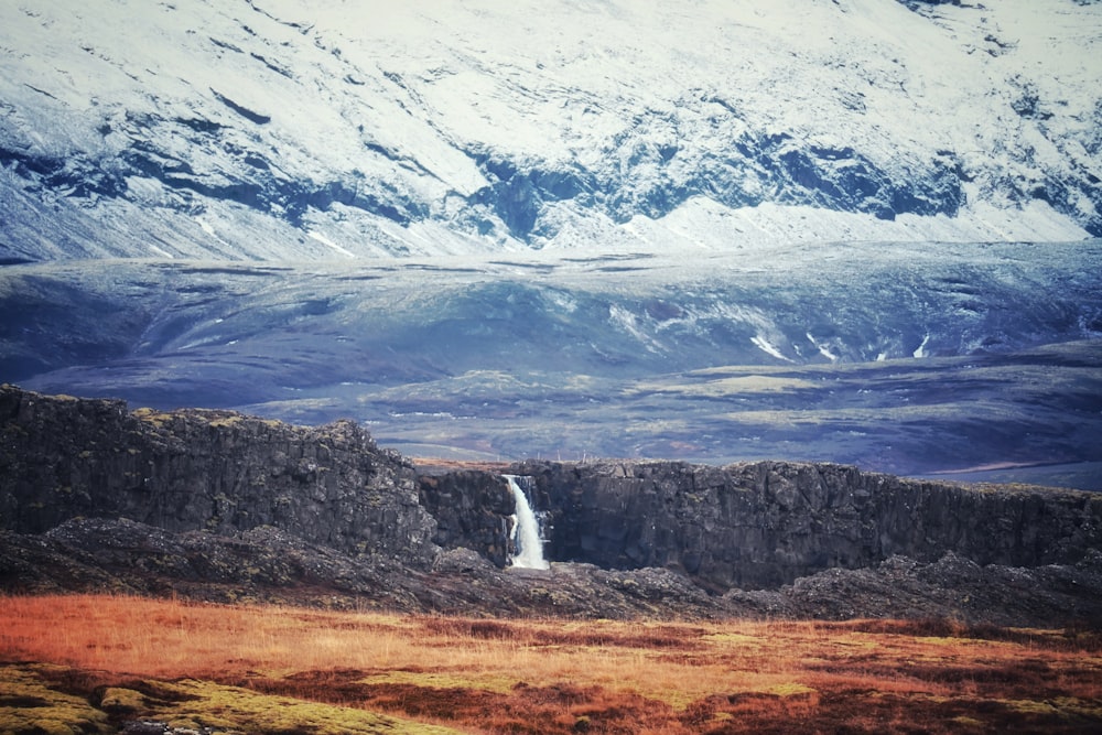 a mountain with a waterfall in the middle of it